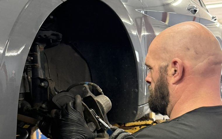 Bear Car Care technician working on a brake caliper